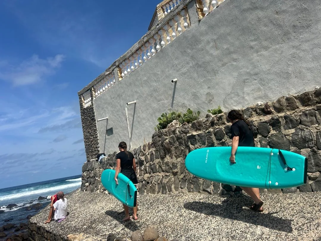 Des surfeurs se dirigent vers l'eau à Ngor, au Sénégal.