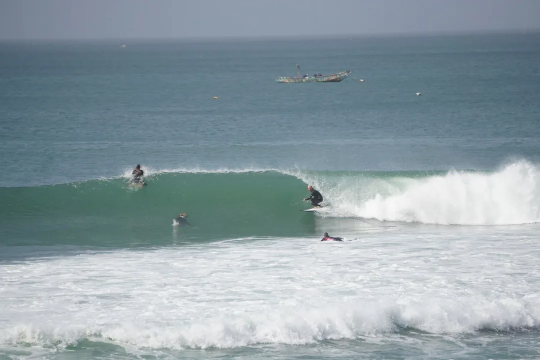 Des surfeurs profitent des vagues à l'île de Ngor au Sénégal.