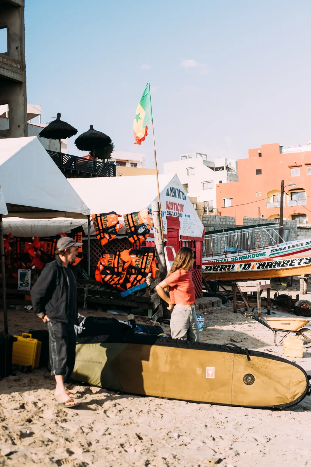 Preparing surf gear on Ngor Island beach.