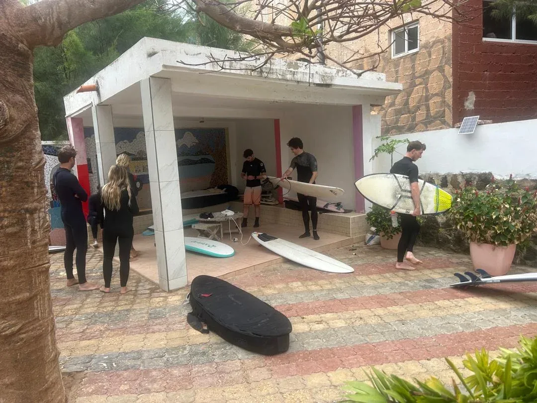 Surfers preparing gear at Ngor Surfcamp.