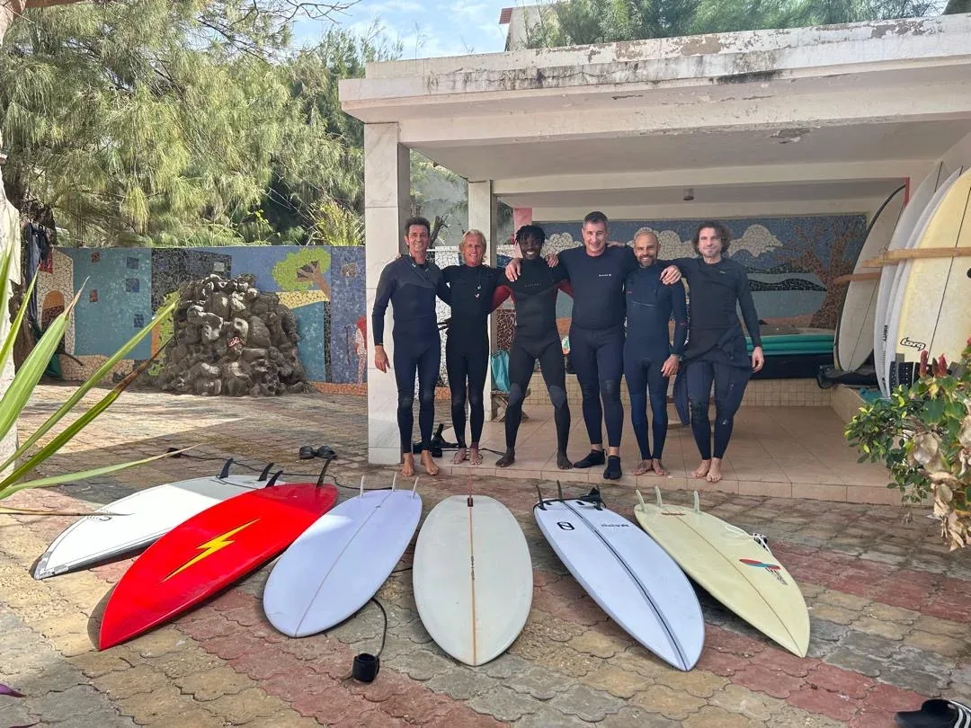 Group of surfers with boards at surf camp