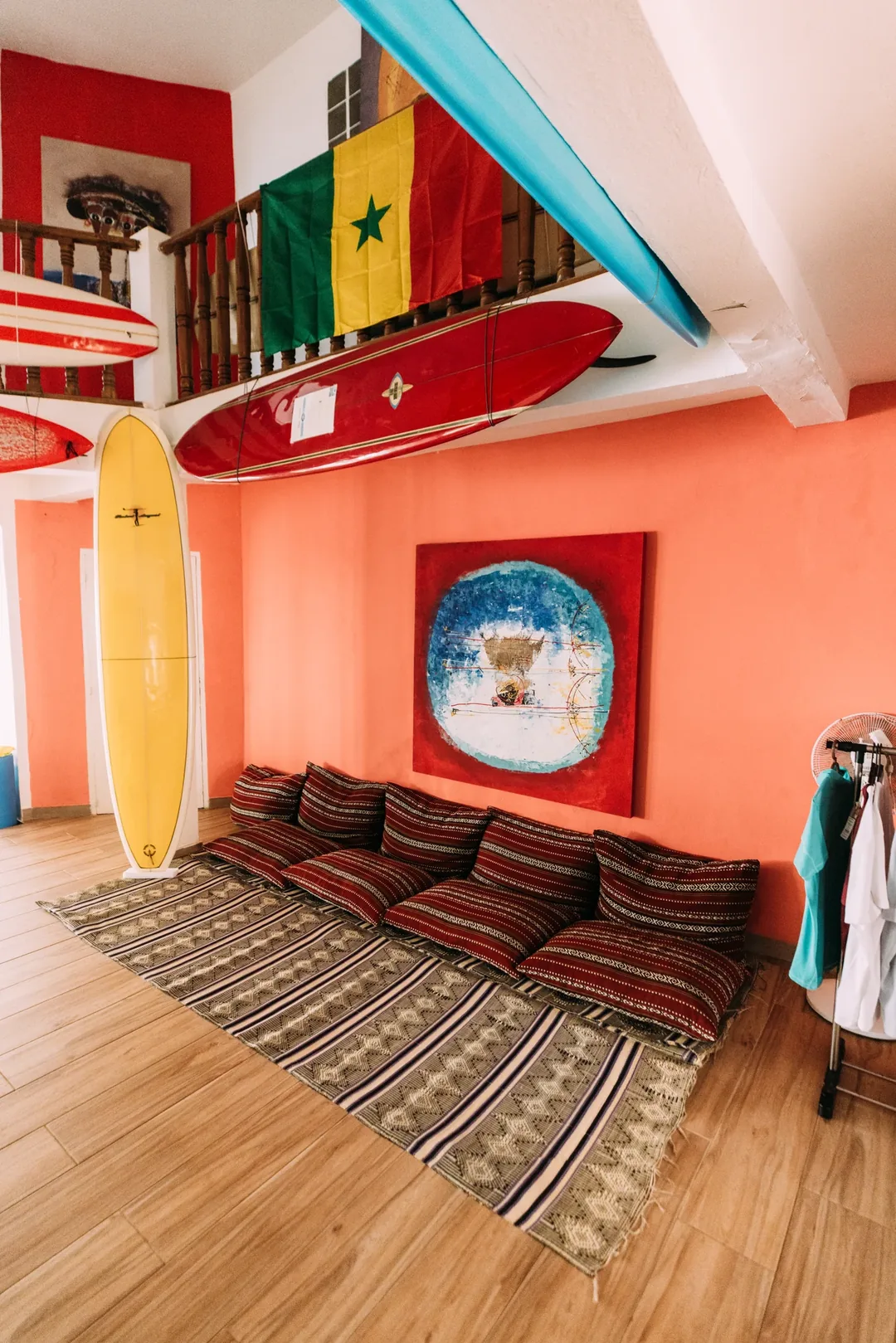 Cozy surf camp lounge with vibrant decor.
