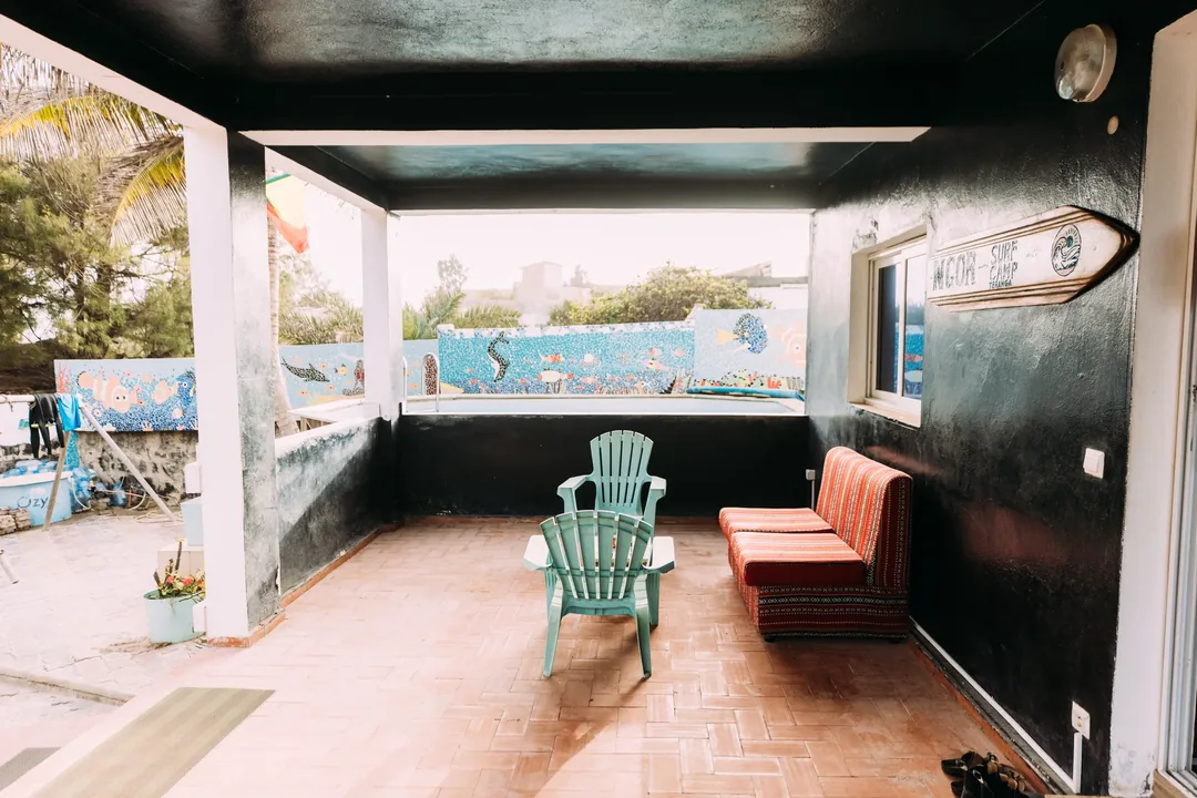 Cozy surf camp terrace with seating area.
