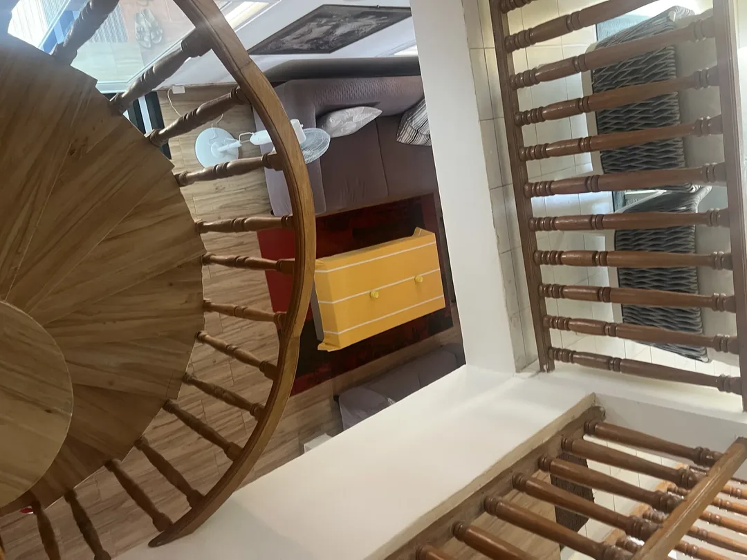 Spiral staircase in surf camp interior.