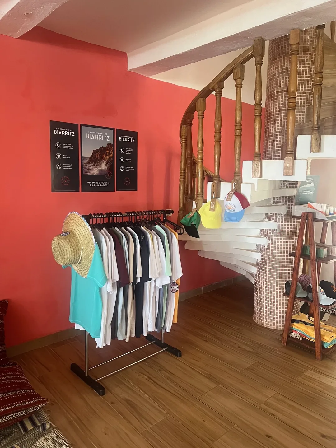 Surf camp interior with clothing rack.