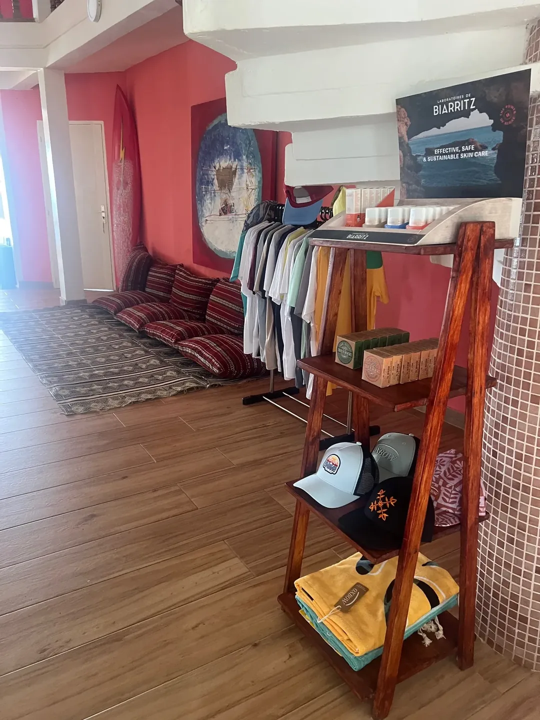 Surf camp interior with gear display.