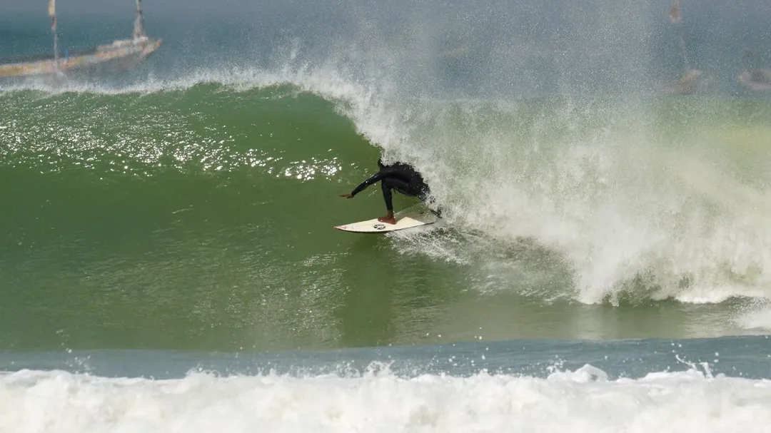Surfer skillfully rides a powerful wave.
