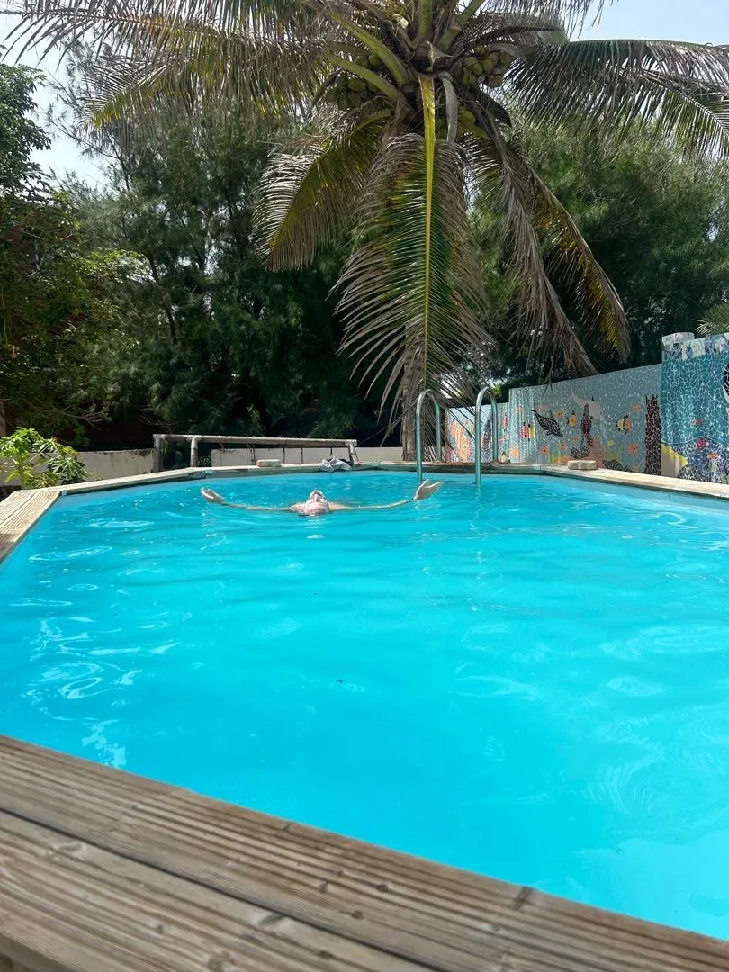 Relaxing in the pool under palm trees.