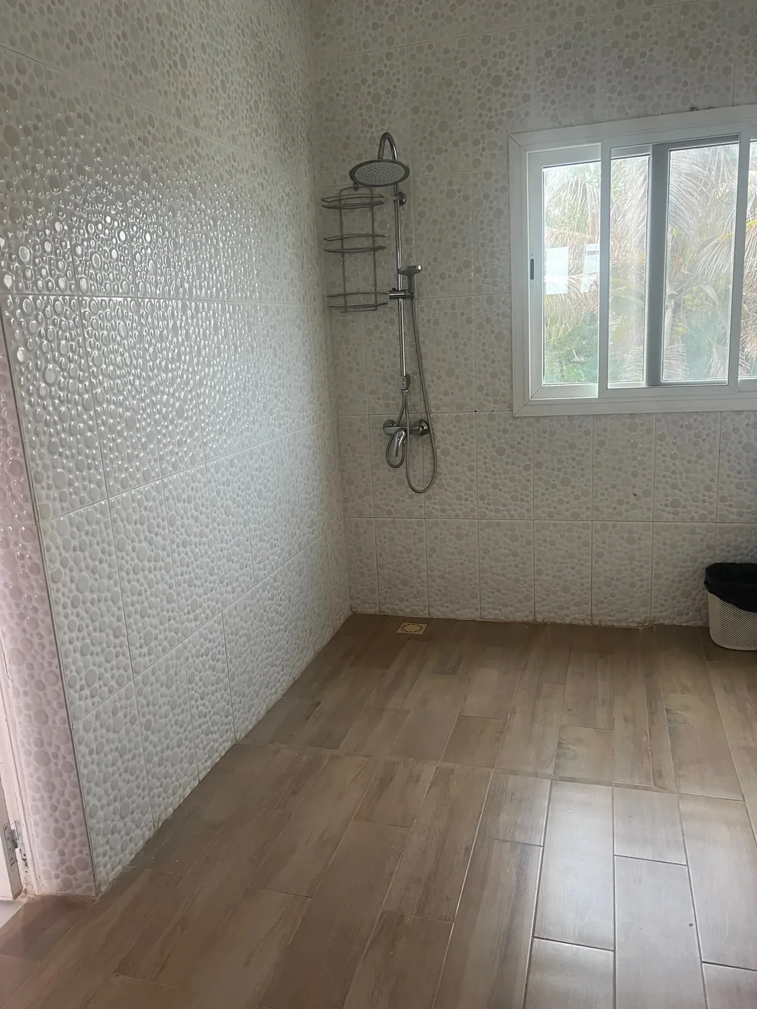 Simple bathroom with pebble-tiled surface.