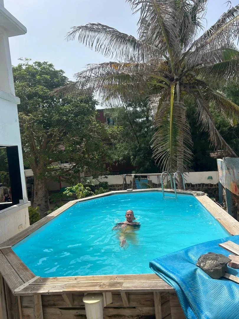 Relaxing in the pool under palm trees.